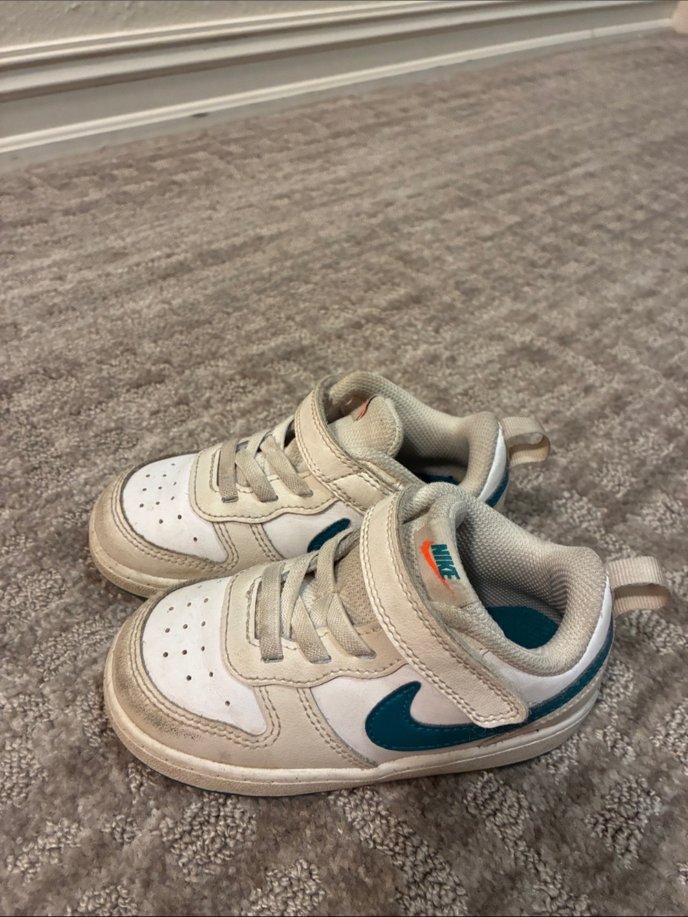 Nike Kids White Sneakers with Teal Swoosh and Orange Logo